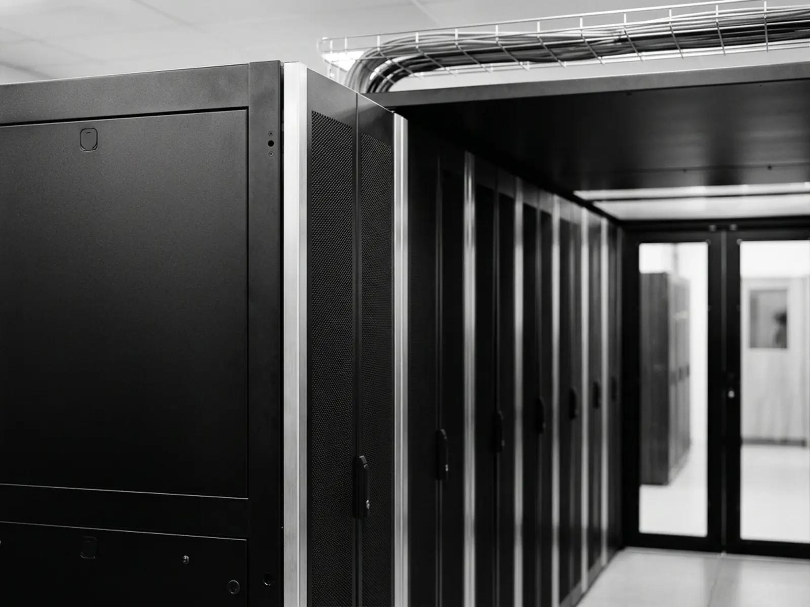 Server cabinets with hot-aisle containment, the kind of sheet-metal work we build (illustrative image)